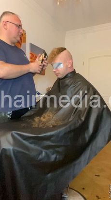 2012 20241118 handcuffed headshave mouth and eyeprotectors buzz and shampoo upright