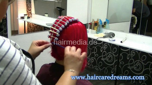 Oliya red perm roller set by Melody in dyeing apron