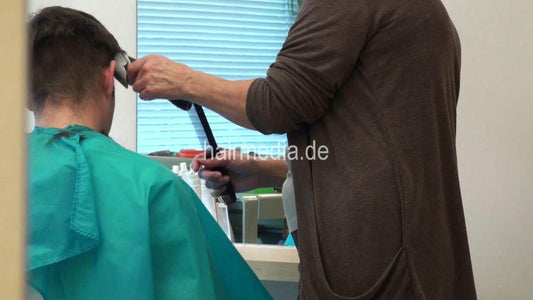 274 young man buzz by mature barberette in green cape