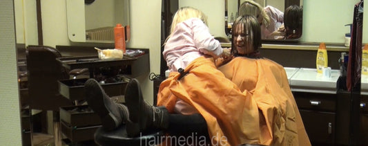 8131 5 Agata sexy haircut by Dzaklina in pink apron, 2 barberettes inside a large orange cape