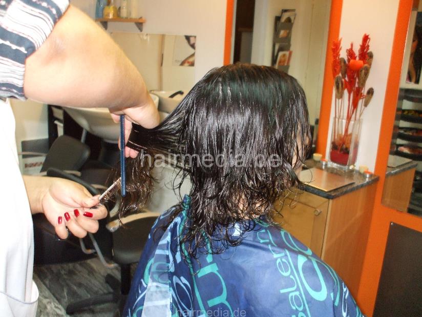 8053 Paula 2 haircut by mature barberette in white apron