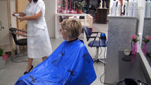 Load image into Gallery viewer, 350 Olga by Talya in white apron salon hair shampooing in blue pvc shampoocape