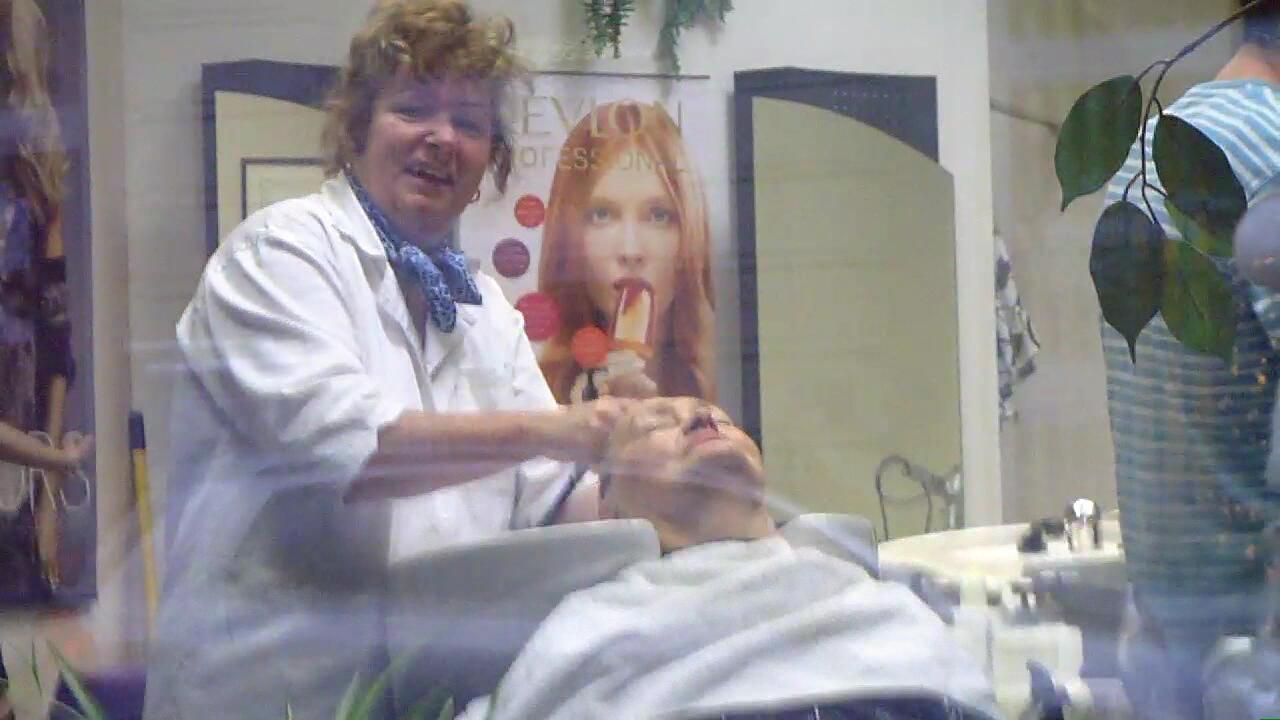 0003 mature shampooing in white apron backward manner