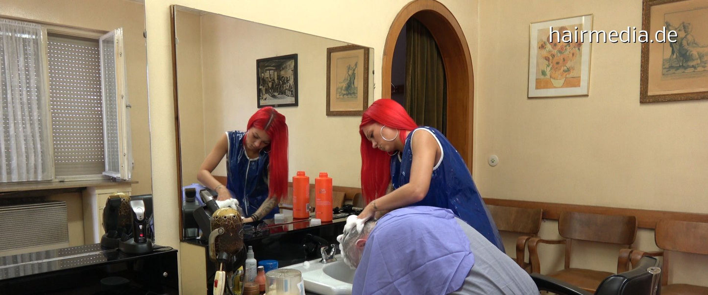 1034 smoking barberette Charline in blue vinyl apron 1 doing forwardshampoo a male