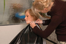 Load image into Gallery viewer, 720 LenaG 1 fake perm shampooing forward manner hairwash in black vinyl cape and apron
