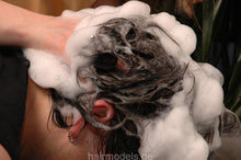 Load image into Gallery viewer, 237 guy by Barberette Tinaj in apron, forward salon hairwash in barbershop