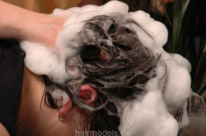 237 guy by Barberette Tinaj in apron, forward salon hairwash in barbershop