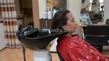 将图片加载到图库查看器，315 Barberette Hasna 4 backward shampooing by barber haircare in red PVC cape sideview