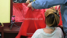 Laden Sie das Bild in den Galerie-Viewer, 9151 AliciaN 1 upright shampooing by barber in heavy red pushbuttonclosure cape