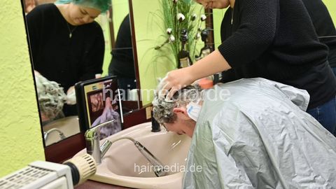 Josh by Jamilla student barberette in rollers, forward shampoo