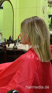 2303 VanessaH 2 chewing forward shampooings by barber in red cape - vertical video