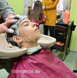 2308 Niklas 1 young boy pampering backward shampooing by barber, mom controlled