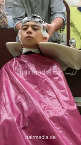 2308 Niklas 1 young boy pampering backward shampooing by barber, mom controlled - vertical video