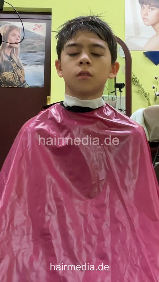 2308 Niklas 2 young boy buzz and cut by barber, mom controlled - vertical video