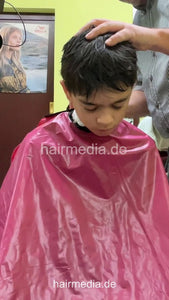 2308 Niklas 2 young boy buzz and cut by barber, mom controlled - vertical video