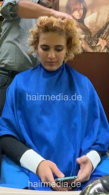 1246 Barberette Nora in apron curly hair forward shampooing by barber vertical video