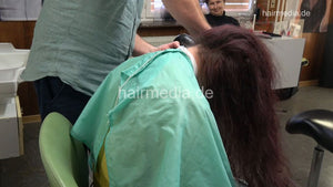 1238 Tetjana 4 wet haircut long and thick hair in green cape by barber and forward blow dry