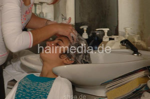 335 Bubble chewing kid shampooing backward by sister in salon