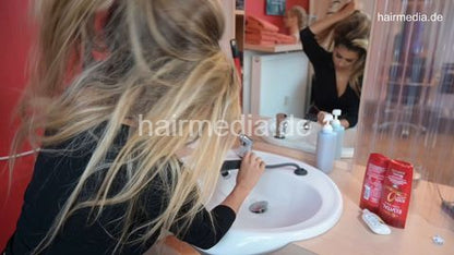 Zoya 1 JMK custom hair self shampooing kneeling forward in leatherpants in white bowl at salon