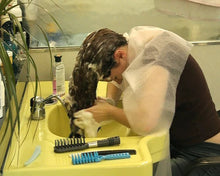 Laden Sie das Bild in den Galerie-Viewer, 959 Steffi barberette self shampooing in salon at forwardbowl in shiny cape