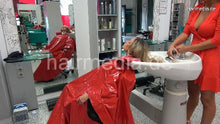 Laden Sie das Bild in den Galerie-Viewer, 1149 03 Barberette OlgaB shampooing Steffi in large vinyl shampoocape in salon backward manner