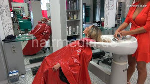 1149 03 Barberette OlgaB shampooing Steffi in large vinyl shampoocape in salon backward manner