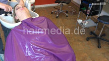 Load image into Gallery viewer, 1152 curvy TineZ by barber backward shampooing in heavy purple pvc cape