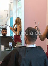 Laden Sie das Bild in den Galerie-Viewer, 1209 Zoya serving male customer cousin 2 haircut in salon red skirt vertical video