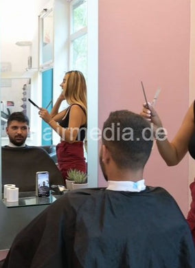 1209 Zoya serving male customer cousin 2 haircut in salon red skirt vertical video