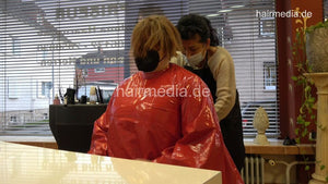 4059 Cara 1 dry haircut in large red vinyl cape