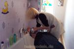 237 barber by Marlene shampooed forward over bathtub forward in apron