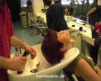 9117 Siglinde salon owner by barber shampooing backward