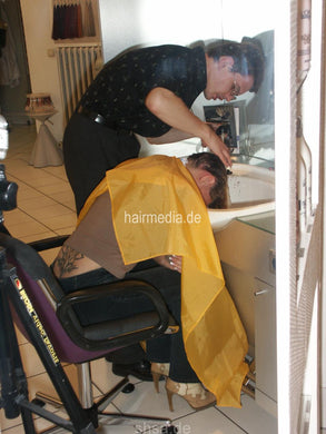 165 NadineH, uprightr. and forward shampooing in salon by barber