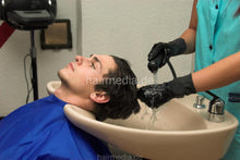 Cargar imagen en el visor de la galería, 294 NadjaZ 05 in black rubber gloves shampooing a guy backward in blue cape and cyan apron