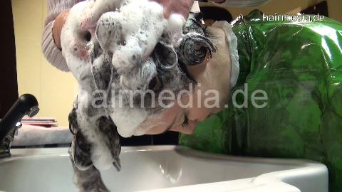 6158 Damaris 2 strong forwardwash salon shampooing in heavy green plastics cape