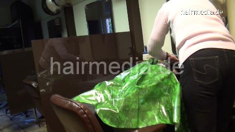 6158 Damaris 2 strong forwardwash salon shampooing in heavy green plastics cape