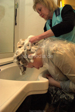 6104 Vera 1 strongest forward salon hairwash by mature senior barberette in green apron