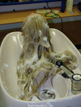 Load image into Gallery viewer, 607 long blond hair by young barber shampooing and wet set