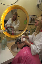 Load image into Gallery viewer, 185 Barberette Valora 1 shampooing a long haired client in Wickelkittel forward