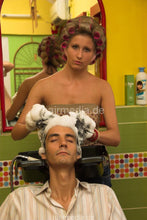 Load image into Gallery viewer, 296 by Sanja 1 male client backward salon shampooing by barberette in rollers, hairnet, earprotectors