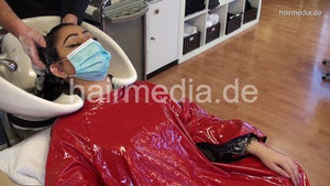 8162 Barberette Mirsada 1 backward wash by barber in her salon red heavy vinyl cape